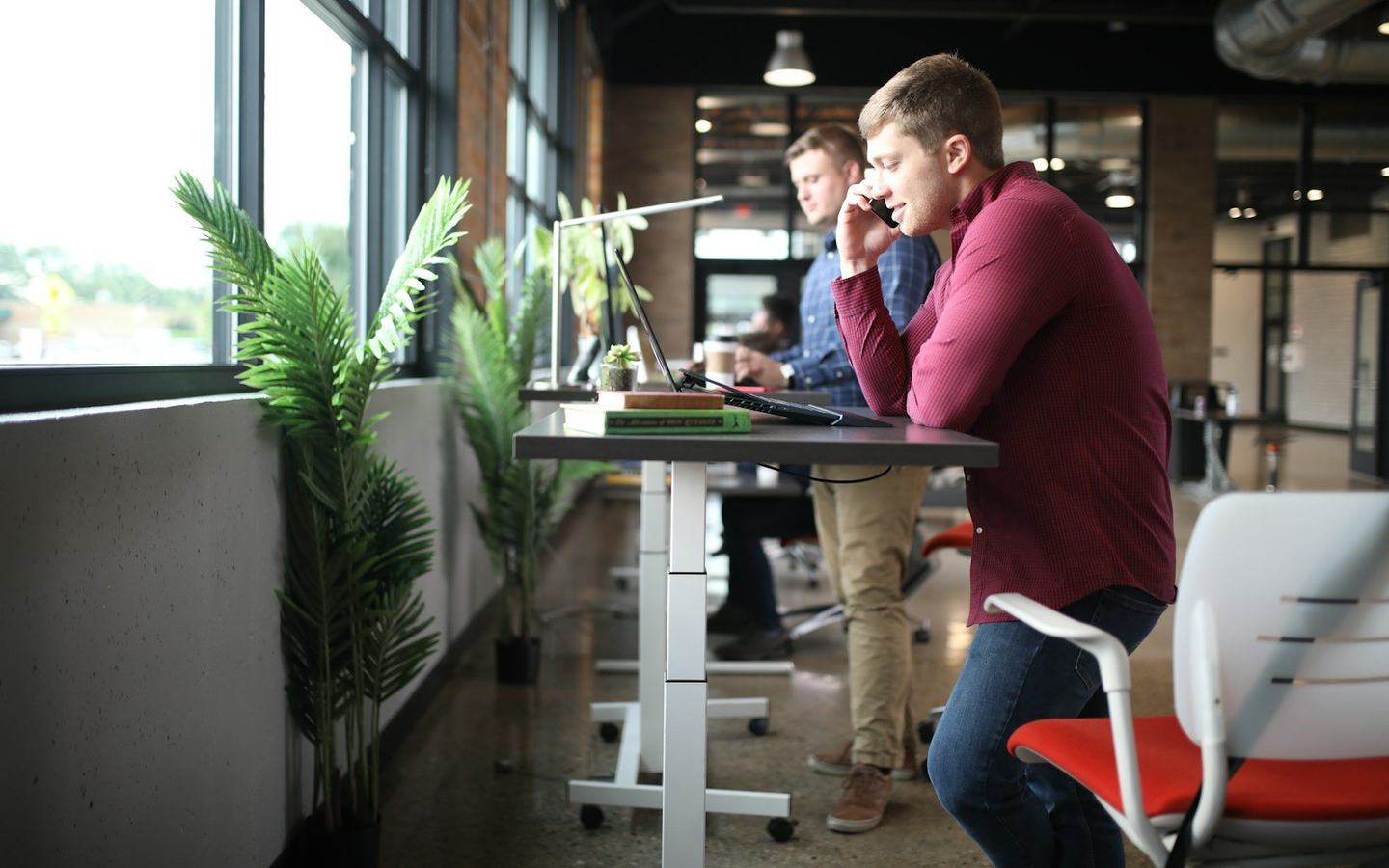 Two Lycheo developers working on a client website in the studio — the same people who write the code talk to you.